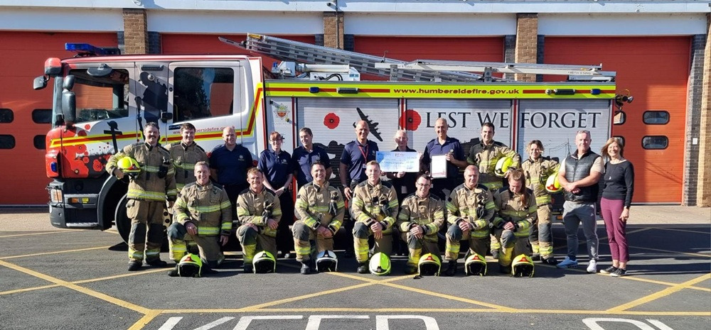 The Fire Fighters Charity recieveing cheque at Peaks Lane Fire Station
