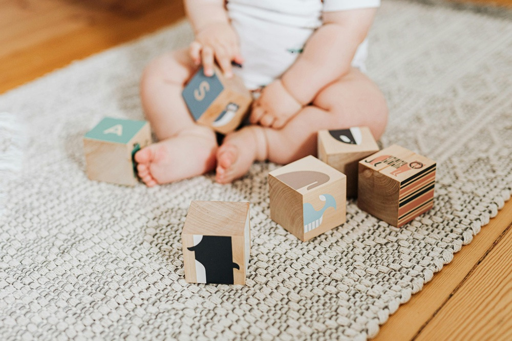 Close up of a baby playing with building blocks