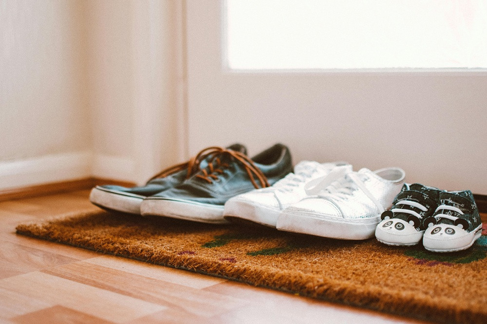 Row of trainers on the door mat
